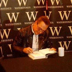 David signs his autobiography for a fan