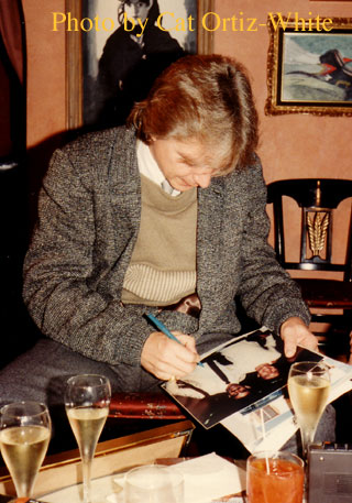 David signs a photo