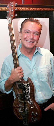 David Cassidy with a guitar being actioned.