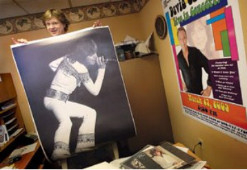John Miller holding a poster of David Cassidy.