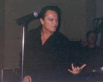 David plays air guitar.
