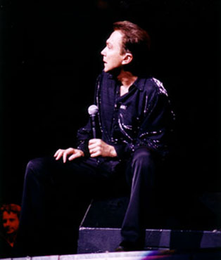 David sits on the stage